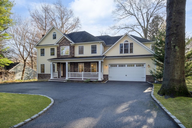 craftsman inspired home featuring covered porch and a garage