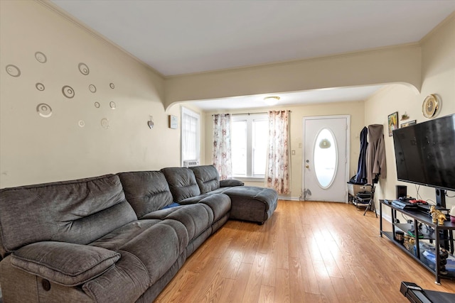 living room with light hardwood / wood-style floors and ornamental molding