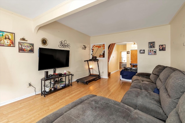 living room featuring wood-type flooring and crown molding