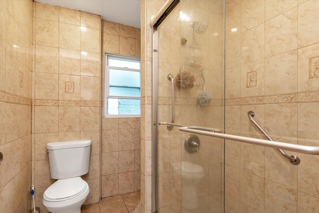 bathroom featuring a shower with door, tile patterned flooring, tile walls, and toilet