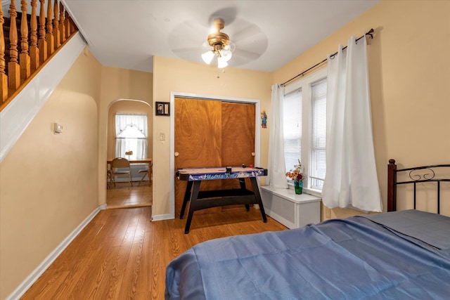 bedroom featuring ceiling fan, a closet, and light hardwood / wood-style floors