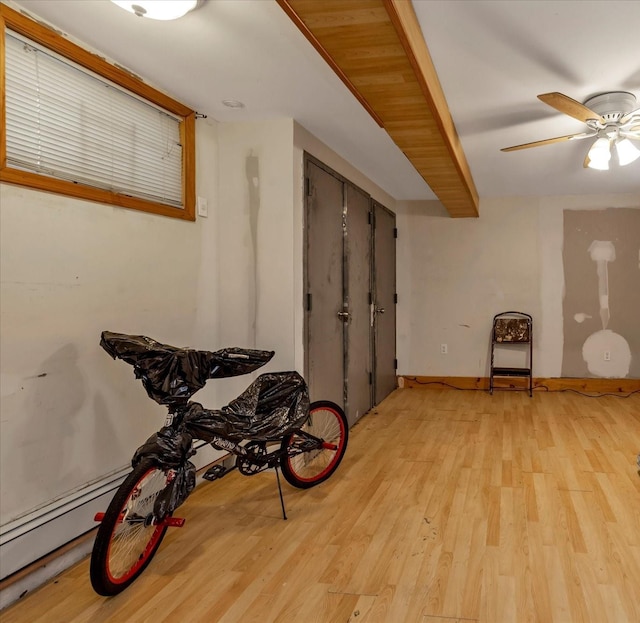 interior space with ceiling fan and light hardwood / wood-style flooring