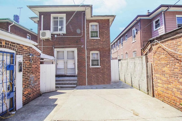 rear view of property with ac unit