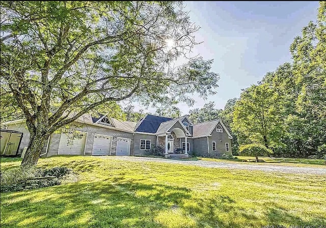 view of front of home featuring a garage and a front lawn