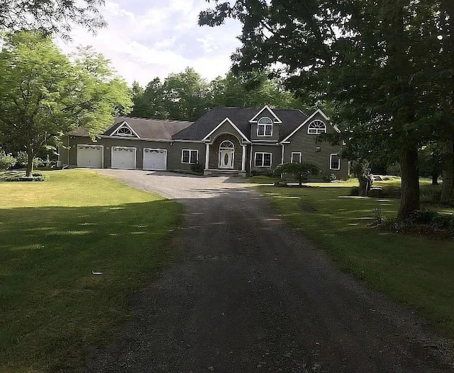 view of front of home featuring a garage and a front lawn