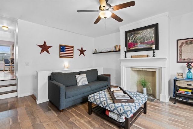 living room with hardwood / wood-style floors and ceiling fan