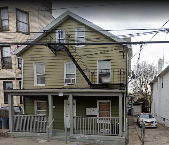 view of front of house with covered porch and cooling unit