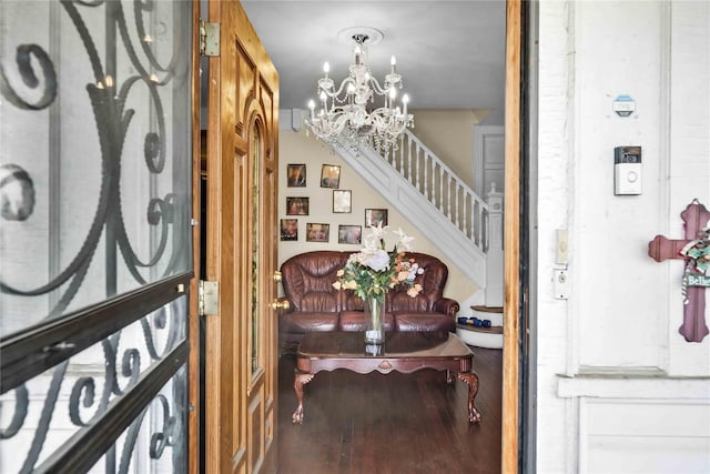 foyer with hardwood / wood-style floors and a notable chandelier