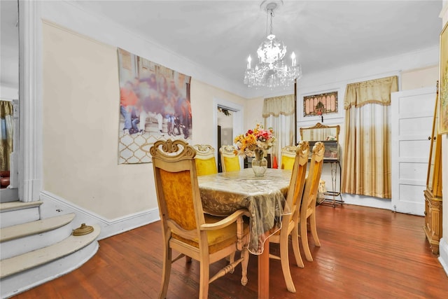 dining space featuring a chandelier, dark hardwood / wood-style floors, and crown molding