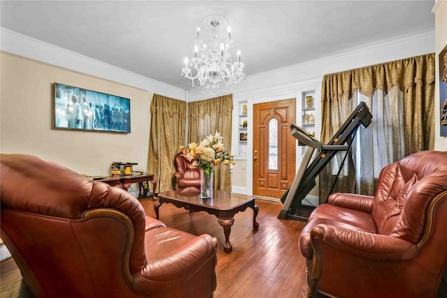 living room featuring wood-type flooring, an inviting chandelier, and ornamental molding