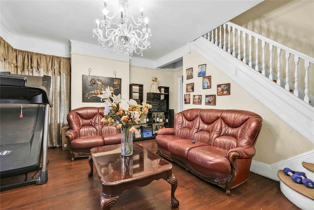 living room with a notable chandelier, ornamental molding, and dark wood-type flooring