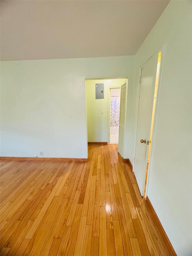 spare room with light wood-type flooring and electric panel