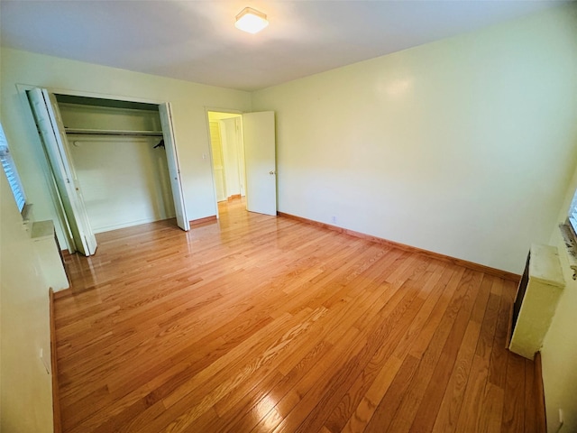 unfurnished bedroom with light hardwood / wood-style floors and a closet