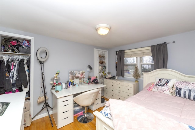 bedroom featuring light hardwood / wood-style floors and a closet