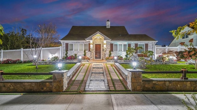 cape cod house with a yard