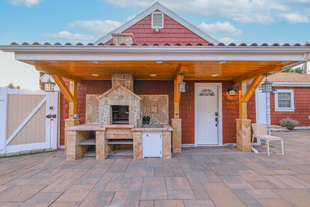 view of patio featuring an outdoor stone fireplace