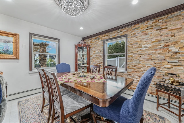 tiled dining area with baseboard heating, plenty of natural light, a chandelier, and ornamental molding