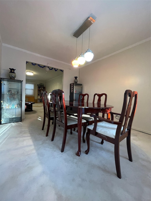 carpeted dining area featuring crown molding