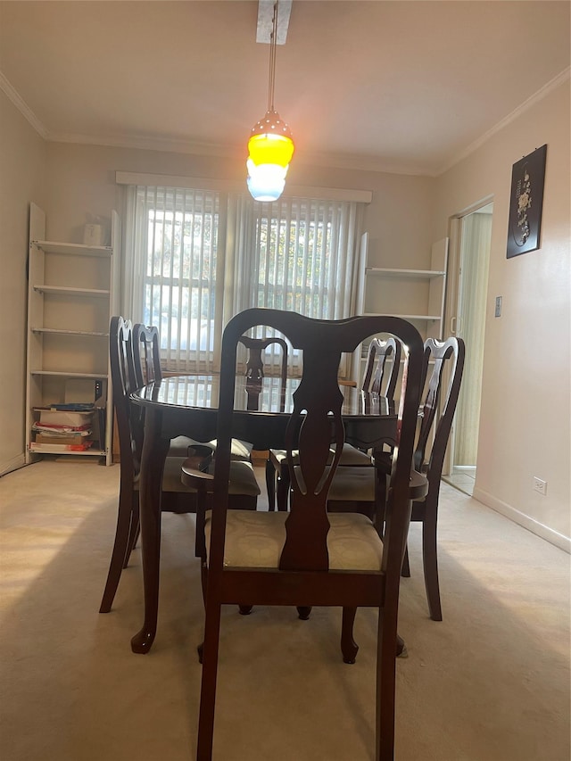 dining space featuring light colored carpet and ornamental molding