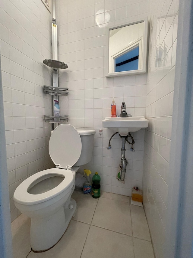 bathroom featuring sink, tile patterned flooring, tile walls, and toilet