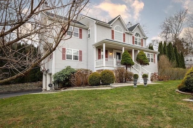 view of front facade featuring a front yard and a porch