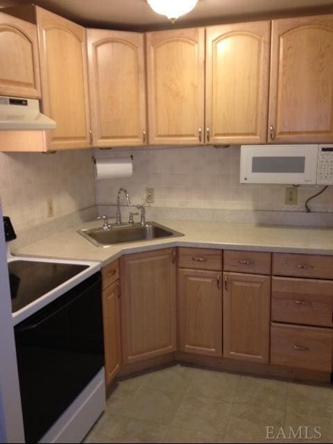 kitchen featuring decorative backsplash, white appliances, sink, and light brown cabinetry