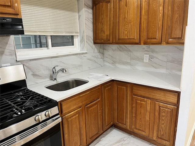 kitchen with decorative backsplash, sink, and stainless steel range oven