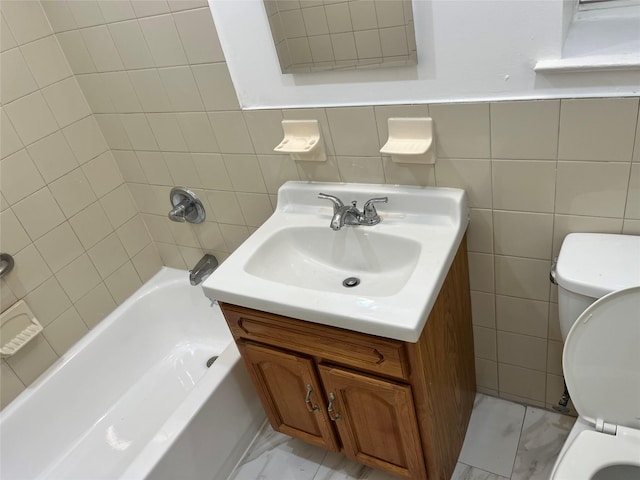 bathroom with vanity, tile walls, and toilet