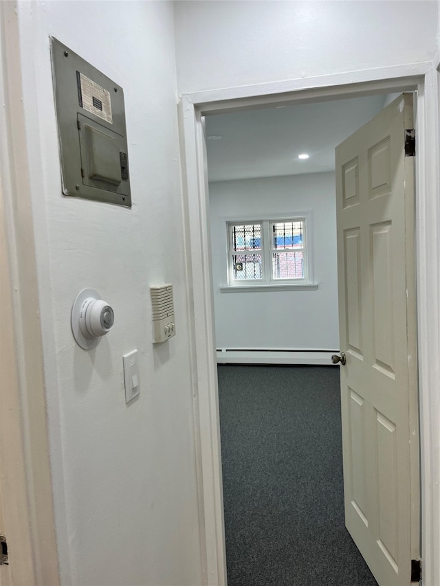 interior space with carpet flooring, electric panel, and a baseboard radiator