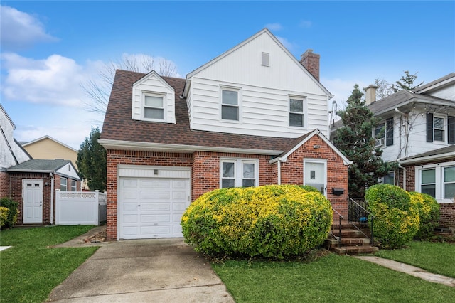 view of front of home featuring a front yard and a garage