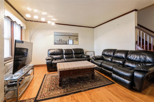 living room featuring wood-type flooring and ornamental molding