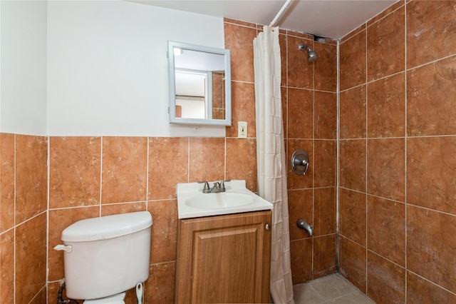 bathroom with a shower with curtain, vanity, tile walls, tile patterned flooring, and toilet