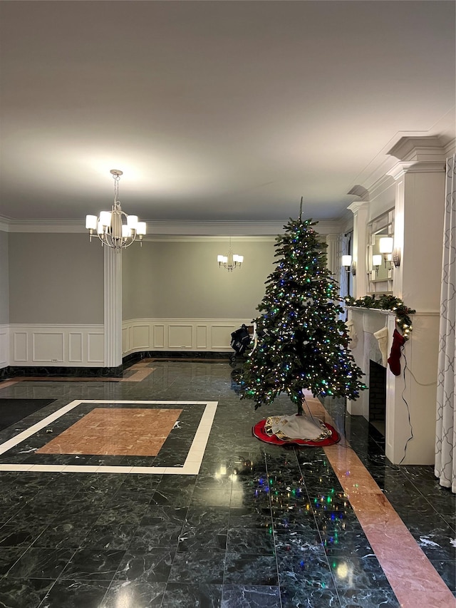 unfurnished dining area featuring a chandelier and crown molding