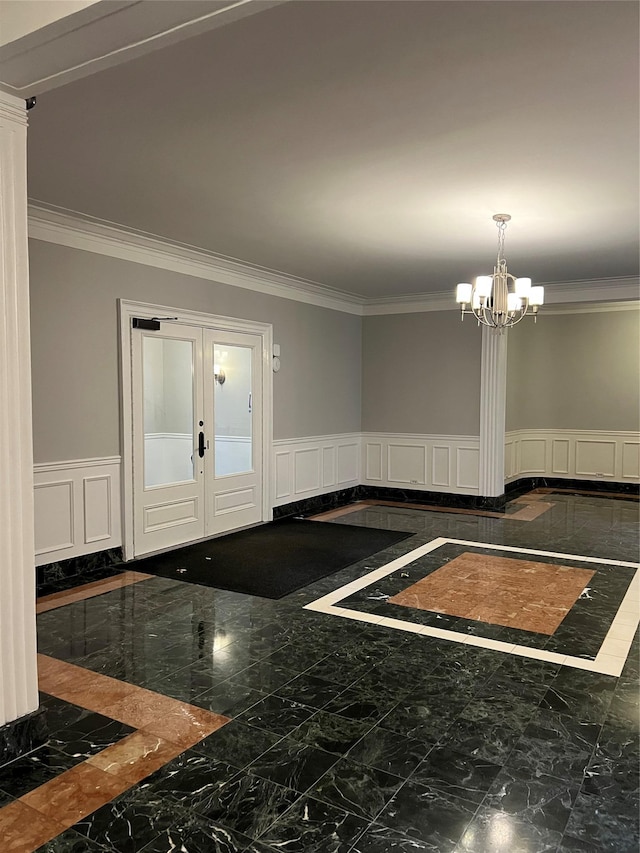 foyer entrance with ornamental molding and a notable chandelier