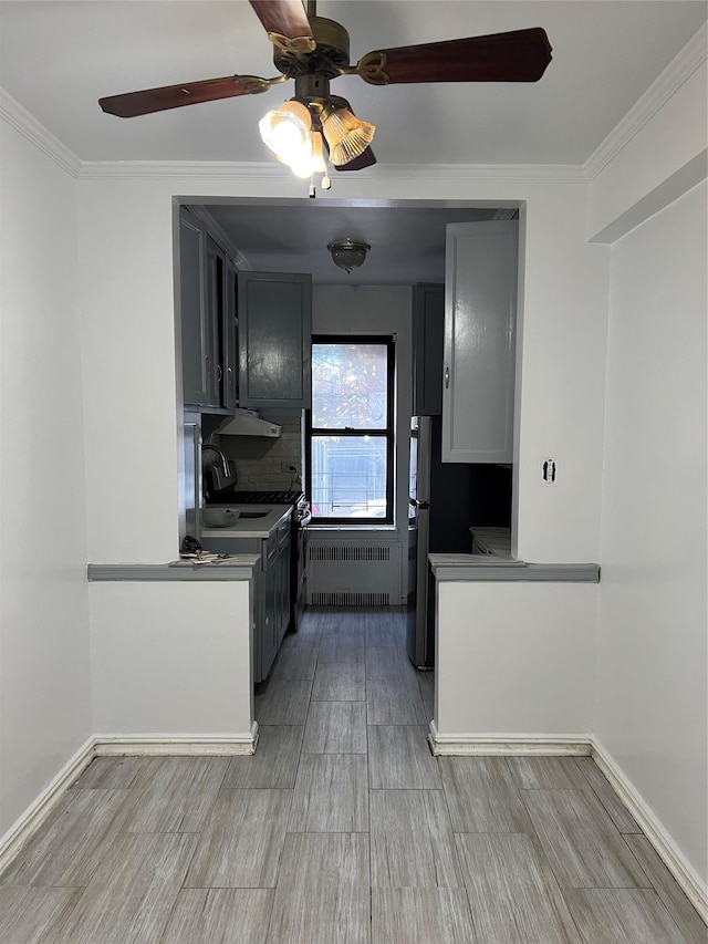 kitchen featuring gray cabinets, radiator heating unit, ornamental molding, and light hardwood / wood-style flooring