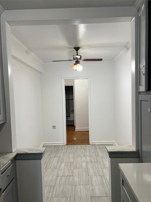 laundry room featuring ceiling fan, ornamental molding, and light hardwood / wood-style flooring