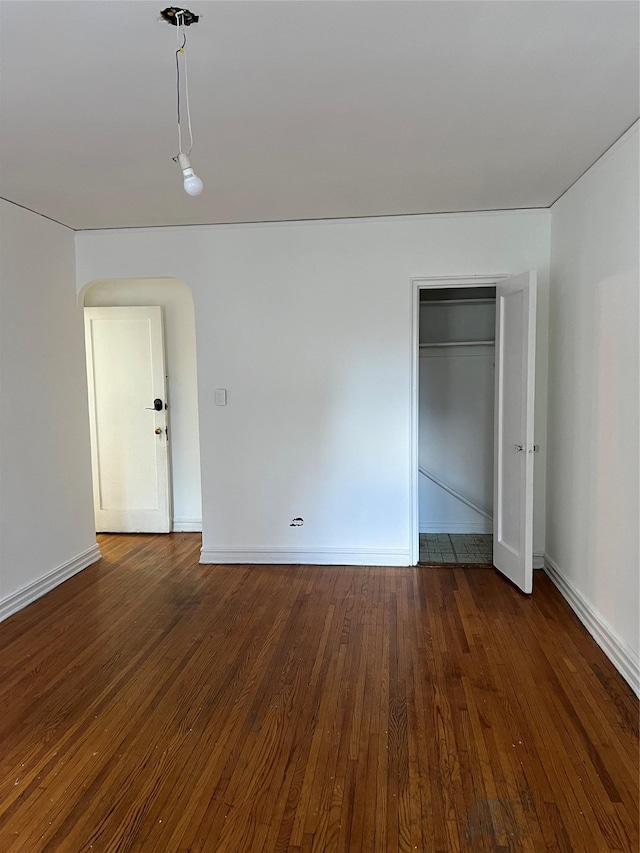 spare room featuring dark hardwood / wood-style flooring