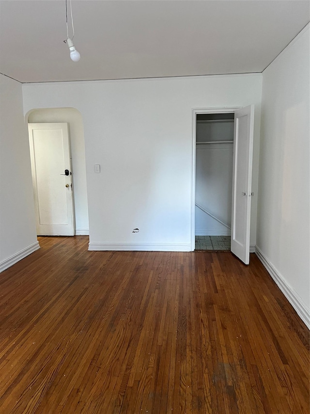 unfurnished bedroom featuring dark hardwood / wood-style flooring