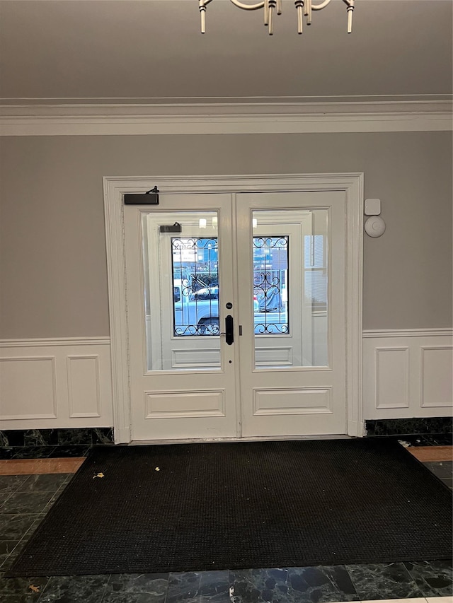 doorway to outside featuring crown molding and french doors