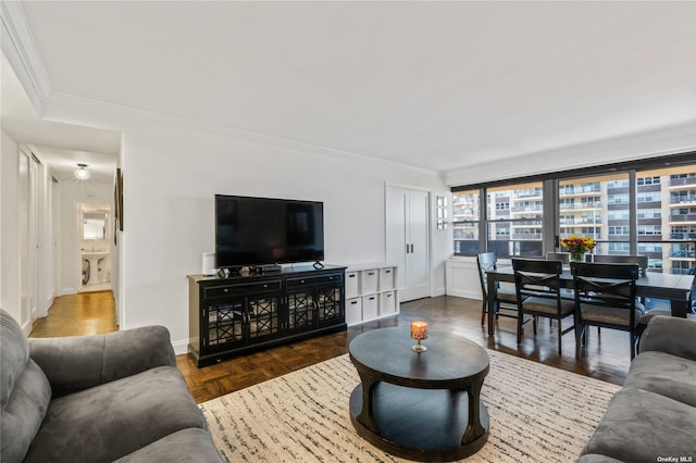 living room with crown molding and dark parquet floors