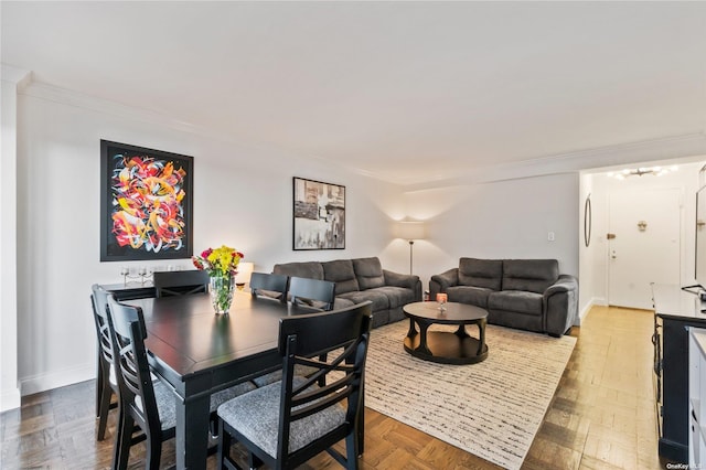 dining area featuring parquet floors and crown molding