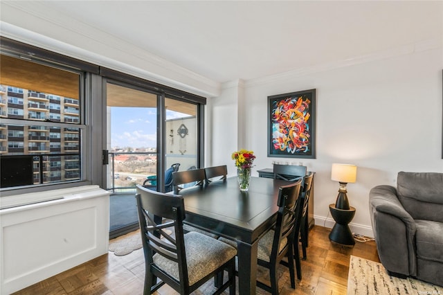 dining space with parquet flooring and ornamental molding