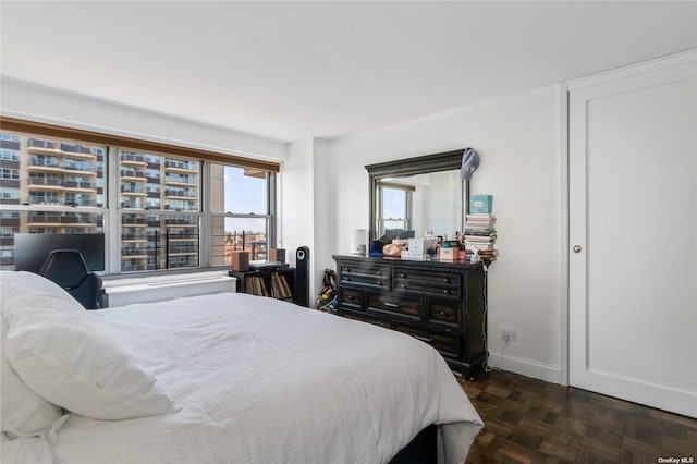 bedroom with dark parquet floors