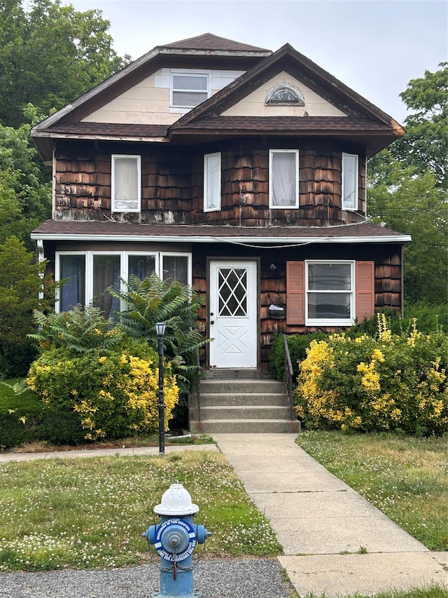 817 Southard St, Baldwin, NY 11510 - view of front of house with a front yard, entry steps, and a shingled roof