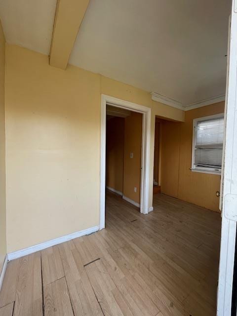 817 Southard St, Baldwin, NY 11510 - empty room featuring light wood-type flooring, baseboards, and beam ceiling