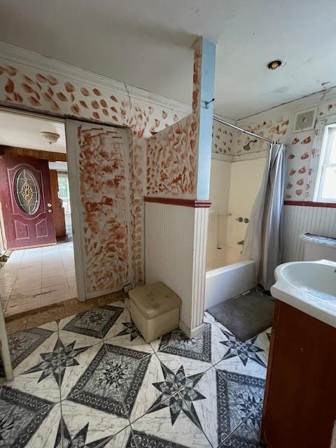 817 Southard St, Baldwin, NY 11510 - bathroom with vanity, wainscoting, shower / tub combo, tile patterned floors, and wallpapered walls