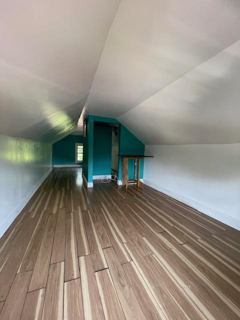 817 Southard St, Baldwin, NY 11510 - additional living space featuring wood finished floors, baseboards, and lofted ceiling