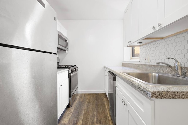 kitchen with white cabinets, stainless steel appliances, dark hardwood / wood-style floors, and sink