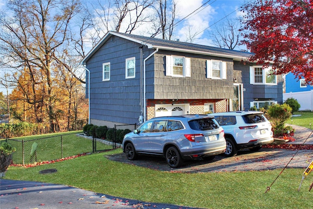 bi-level home with a front lawn