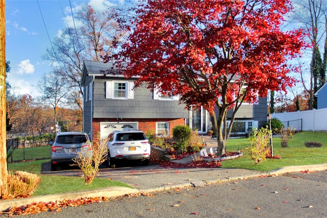 view of front of home featuring a garage and a front lawn